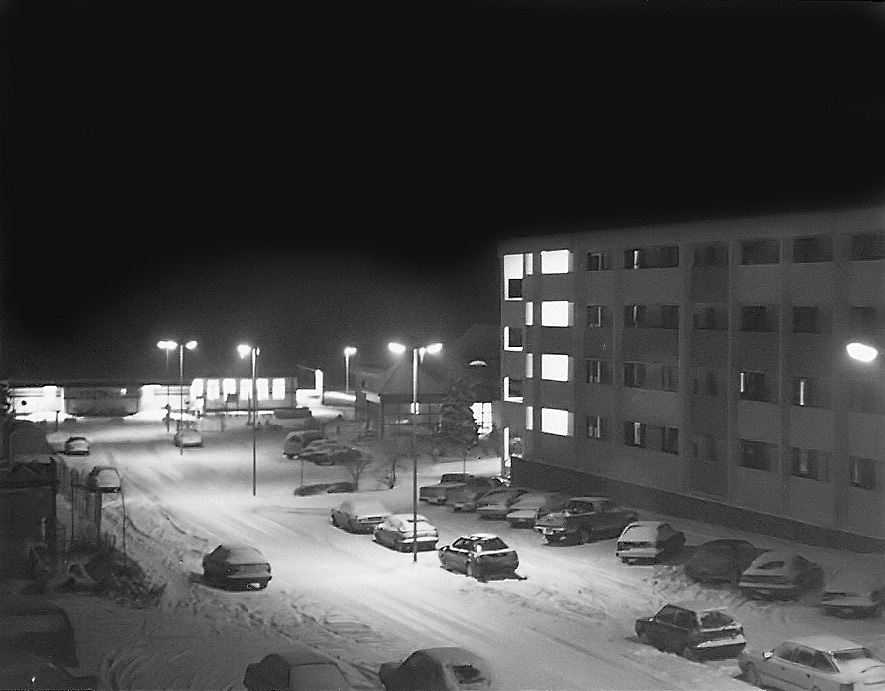 The post office and NCO club are seen through the snow.