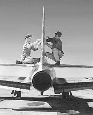 Pete Batten and Ted Barber masking vertically for chevrons to be painted. Sembach, circa 1953.